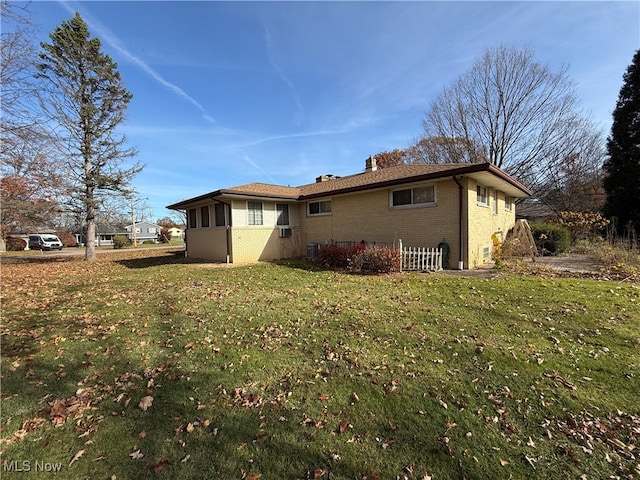 view of property exterior featuring a lawn