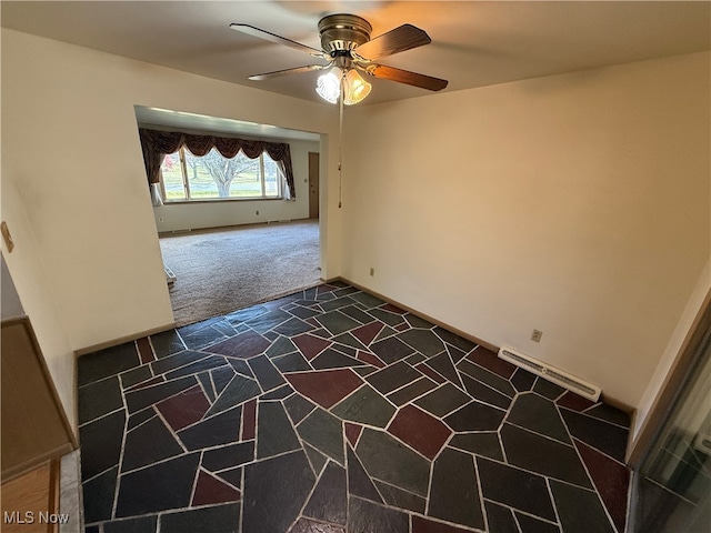 carpeted spare room featuring ceiling fan