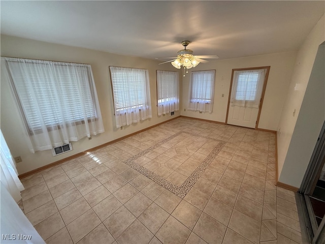 interior space with light tile patterned flooring, ceiling fan, and a healthy amount of sunlight