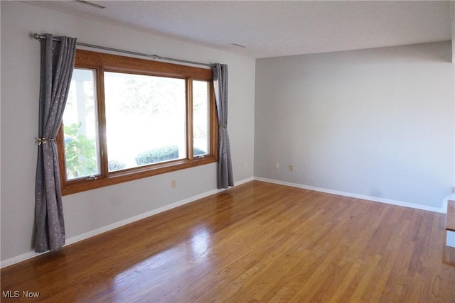 unfurnished room featuring hardwood / wood-style floors