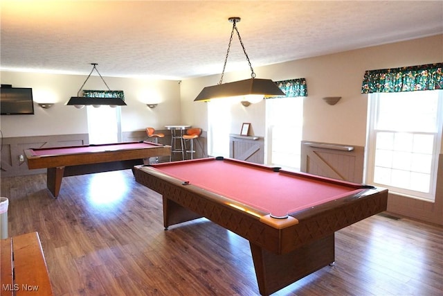 recreation room featuring pool table, wood-type flooring, and a textured ceiling