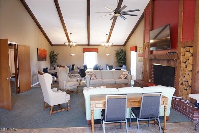 carpeted living room with beamed ceiling, a fireplace, ceiling fan with notable chandelier, and high vaulted ceiling