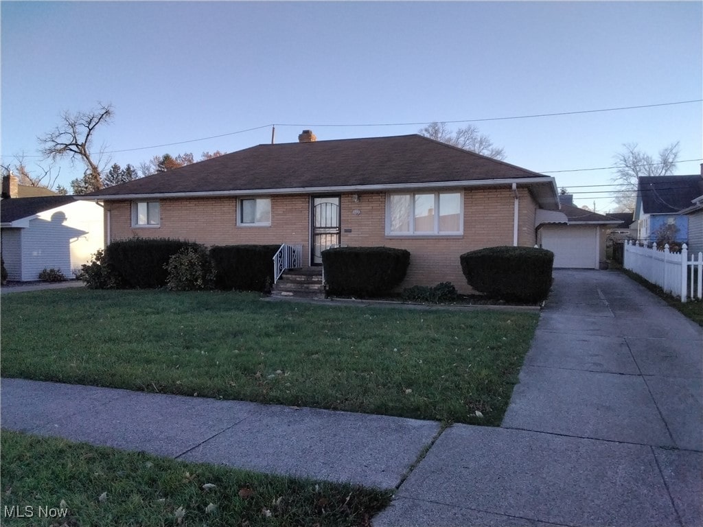 single story home with a garage and a front yard