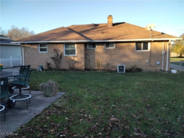 back of house with a yard and a patio area