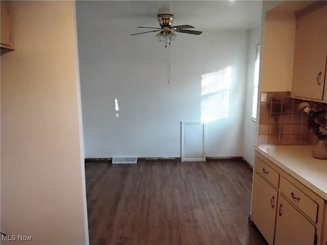 unfurnished dining area with dark hardwood / wood-style flooring and ceiling fan