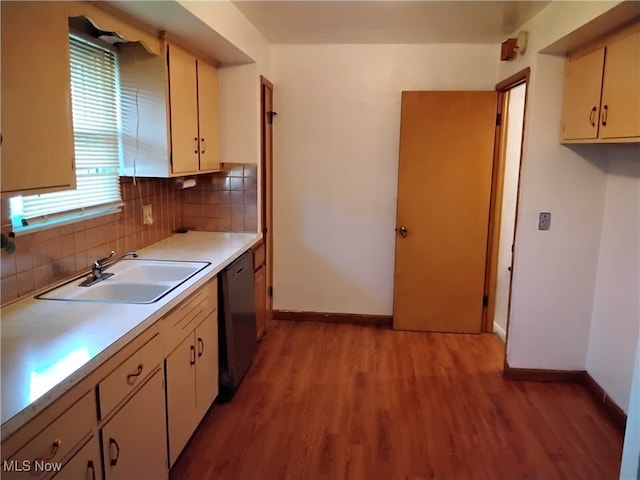 kitchen with light hardwood / wood-style floors, cream cabinets, dishwasher, sink, and tasteful backsplash