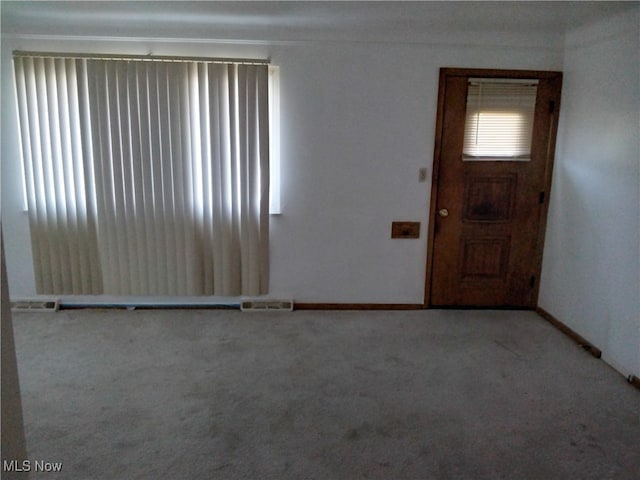 view of carpeted foyer entrance