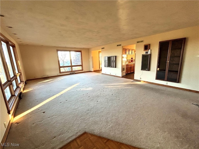 unfurnished living room featuring a textured ceiling