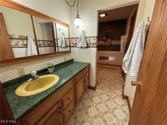 bathroom with decorative backsplash and vanity