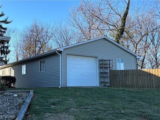 garage featuring a lawn