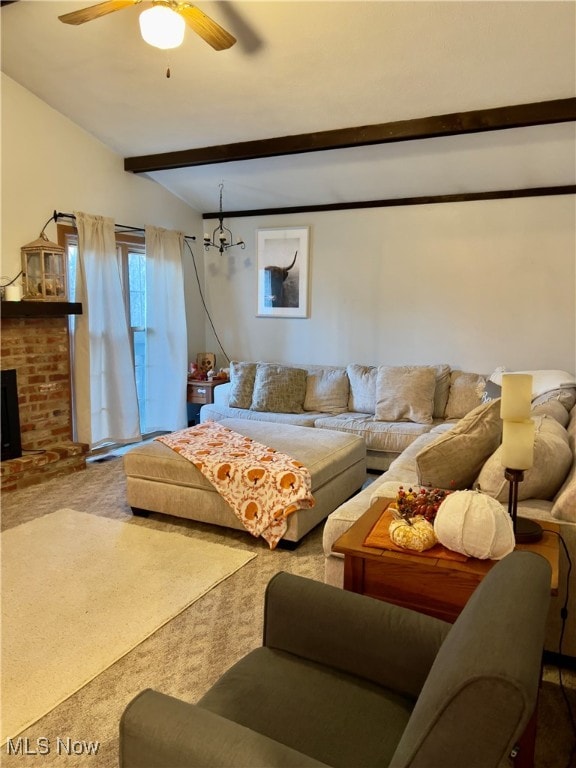 living room with lofted ceiling with beams, carpet flooring, ceiling fan, and a fireplace