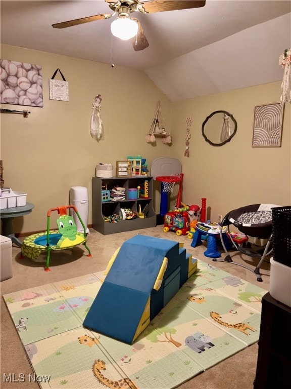 game room with ceiling fan, vaulted ceiling, and carpet