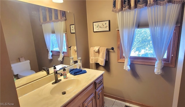 bathroom featuring vanity, toilet, and tile patterned floors