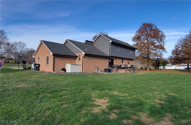 view of side of home with a yard, central AC unit, and a patio area