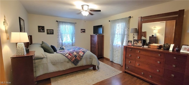 bedroom featuring ceiling fan and dark wood-type flooring