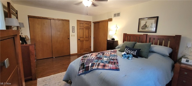 bedroom with ceiling fan and dark wood-type flooring