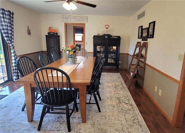 dining area featuring a wealth of natural light, ceiling fan, and dark hardwood / wood-style floors