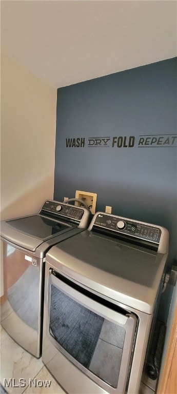 clothes washing area featuring washer and clothes dryer