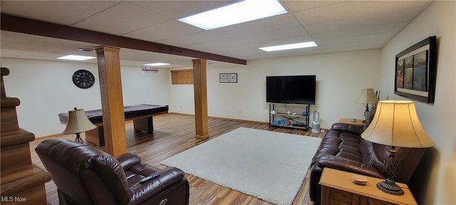 living room featuring a paneled ceiling and hardwood / wood-style flooring