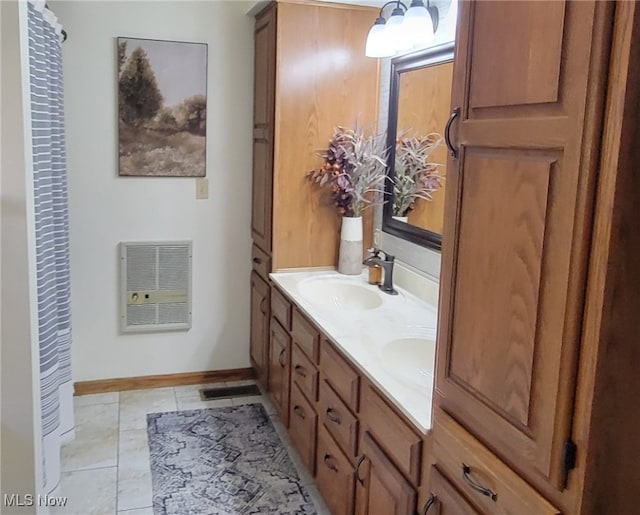 bathroom featuring tile patterned floors, heating unit, and vanity