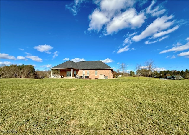 back of house with a lawn