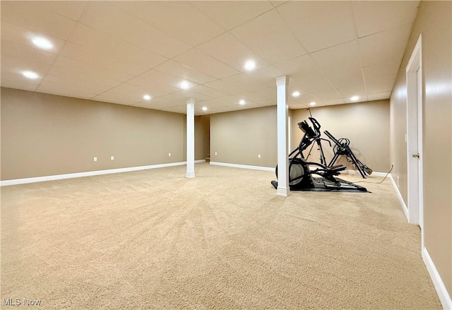 exercise area with a drop ceiling and light colored carpet