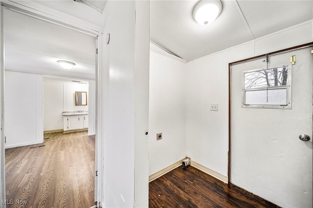 washroom featuring electric dryer hookup, sink, and dark hardwood / wood-style flooring