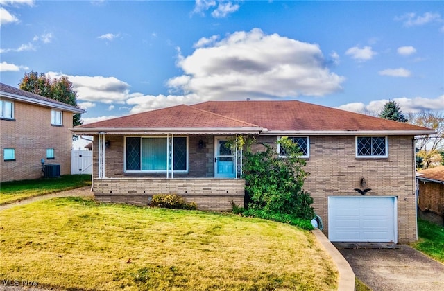 view of front facade featuring a garage, cooling unit, and a front lawn