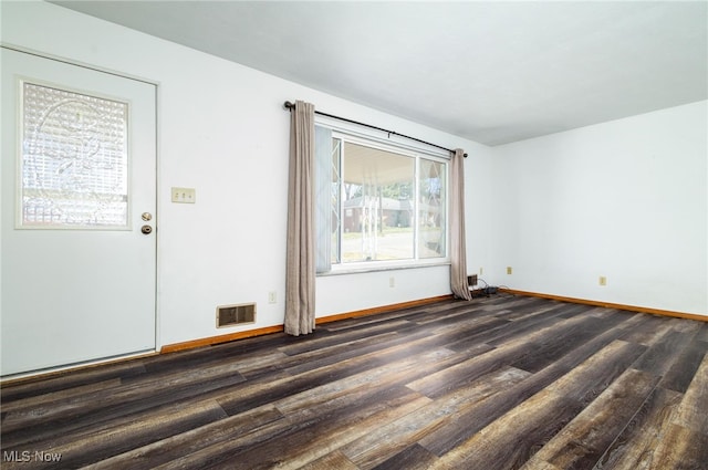 spare room featuring dark hardwood / wood-style floors