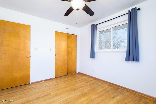 unfurnished bedroom featuring a closet, light wood-type flooring, and ceiling fan