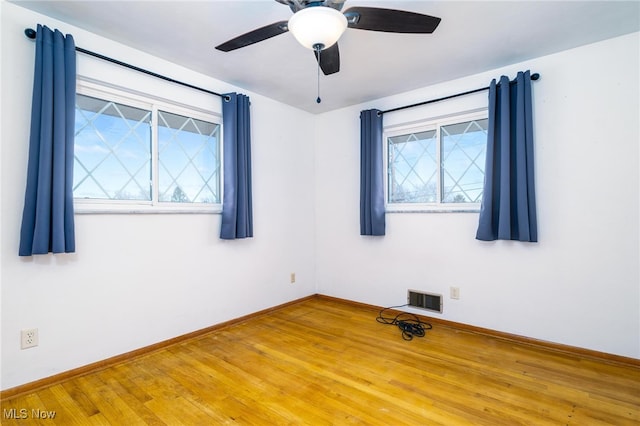 empty room featuring wood-type flooring and ceiling fan