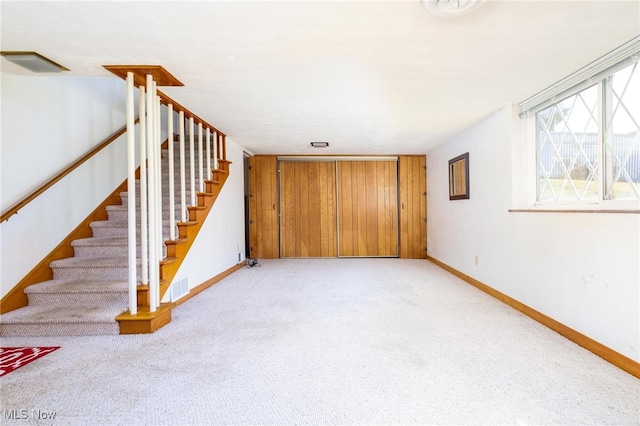 unfurnished living room with light colored carpet