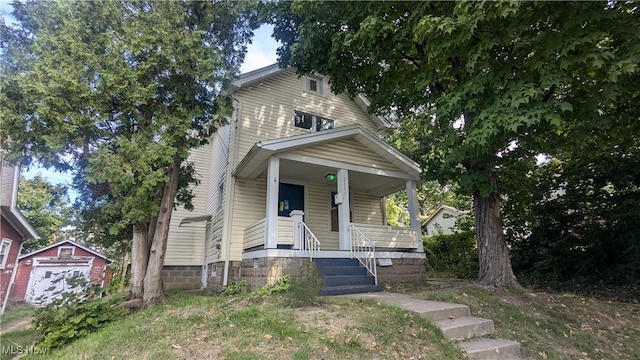 view of front facade featuring an outbuilding and a porch