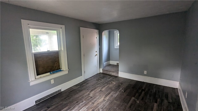 unfurnished room featuring dark hardwood / wood-style flooring