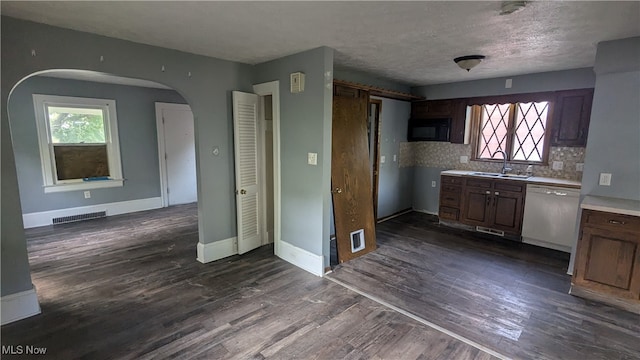 kitchen featuring dishwasher, decorative backsplash, dark wood-type flooring, and sink