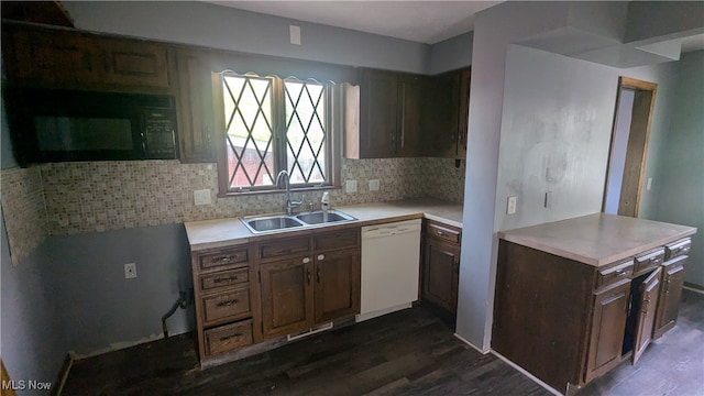 kitchen featuring sink, white dishwasher, backsplash, and dark hardwood / wood-style floors