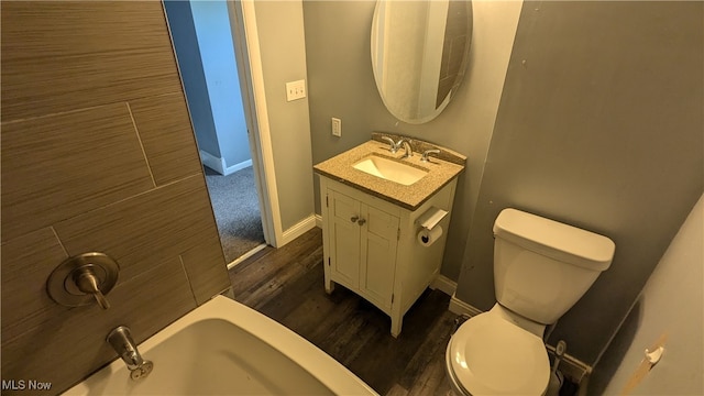 bathroom with toilet, a washtub, vanity, and wood-type flooring