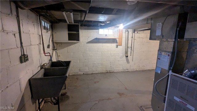 basement with sink and heating unit