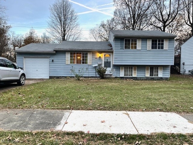 view of front of property with a garage and a front yard