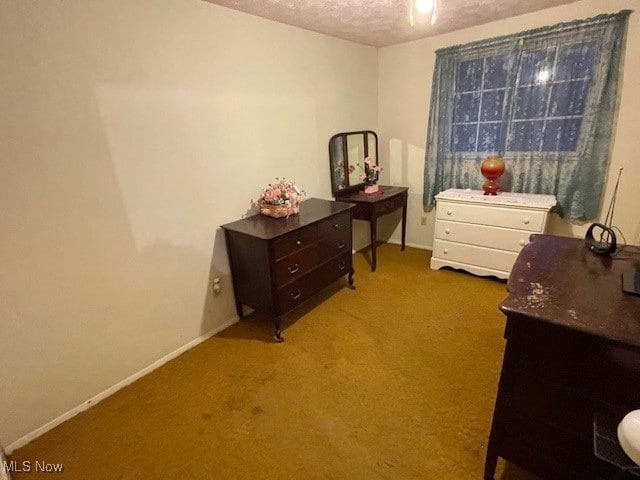 carpeted bedroom featuring a textured ceiling