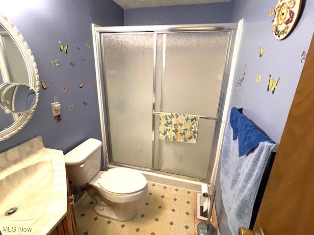 bathroom featuring walk in shower, vanity, and toilet