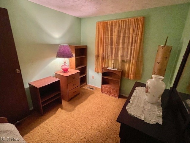 carpeted bedroom with a textured ceiling