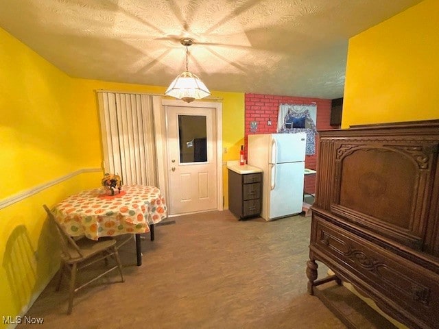 interior space with ceiling fan, a textured ceiling, and white fridge