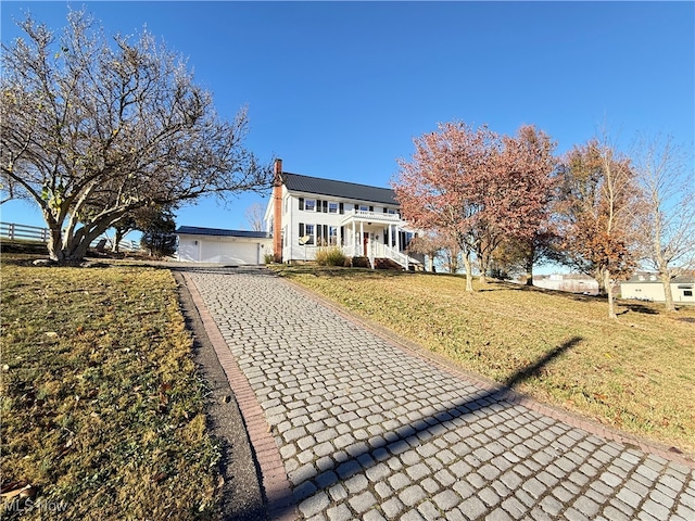 view of front of property with a garage and a front lawn