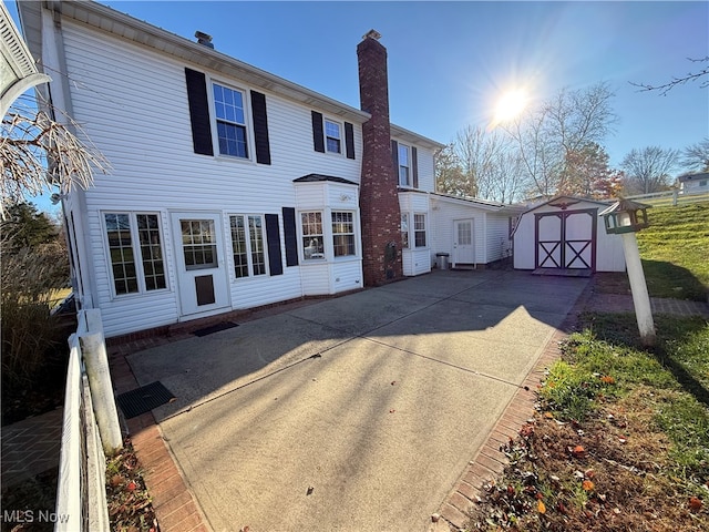 rear view of property with a shed