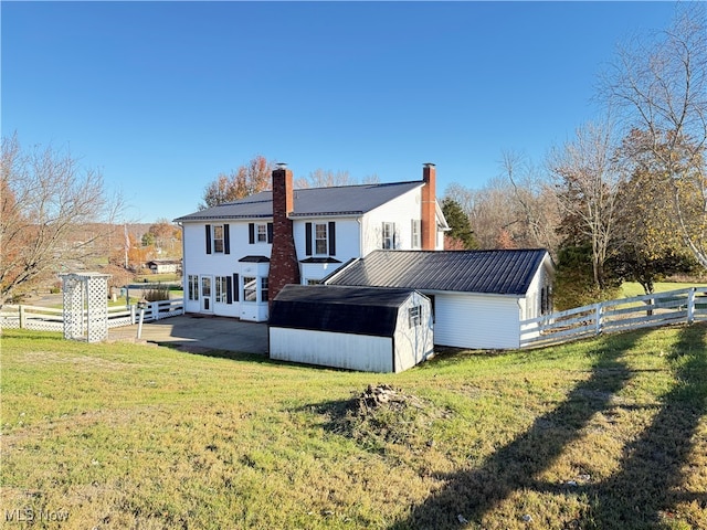 rear view of house with a yard