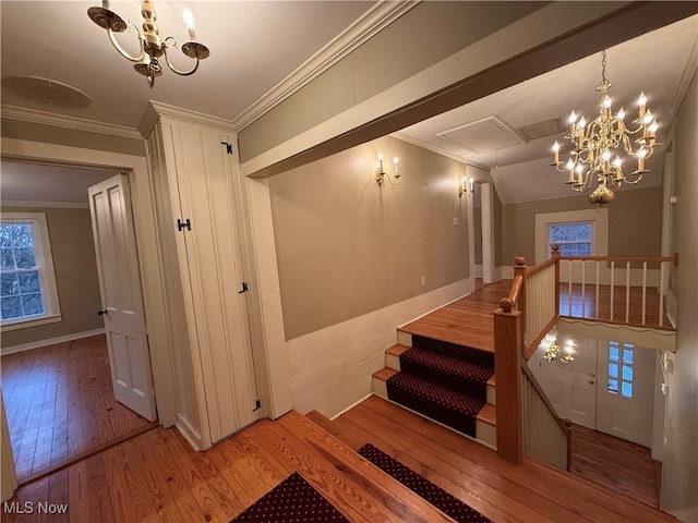 staircase featuring hardwood / wood-style floors and ornamental molding