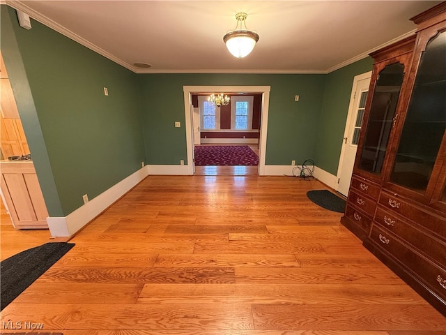 interior space with light wood-type flooring and ornamental molding