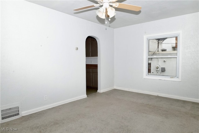 carpeted spare room with ceiling fan