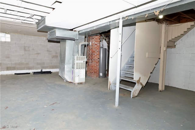 basement featuring water heater and heating unit